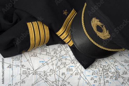 Fototapeta captain uniform over an aeronautical navigation chart