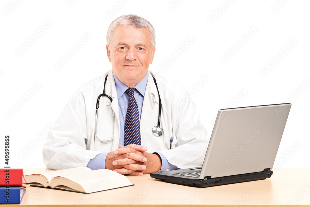 A mature doctor in his office posing A mature doctor in his office posing
