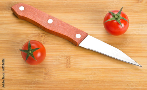 Short kitchen knife on chopping board