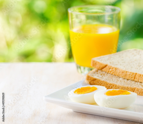 Boiled egg  toasts and orange juice.