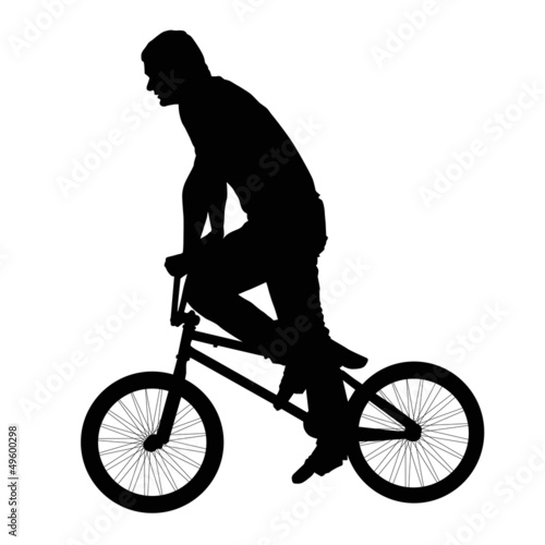 Black silhouette of a young man on a bike