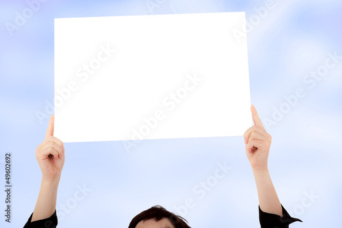 Woman holding up blank poster photo