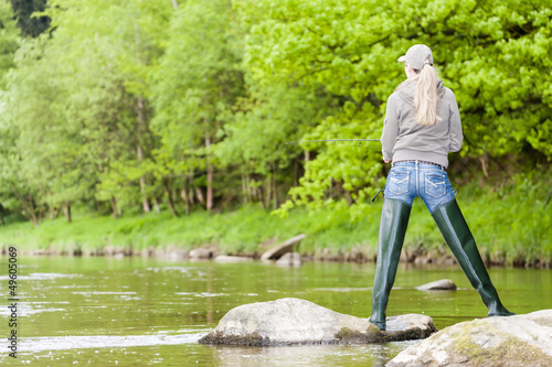 woman fishing in Sazava river, Czech Republic photo