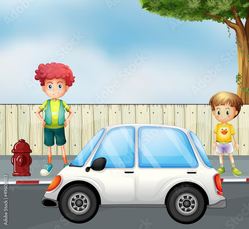 A boy and a child at the street with a car