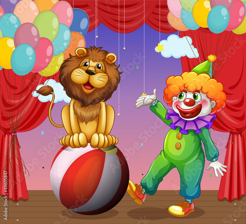 A lion and a clown at the circus