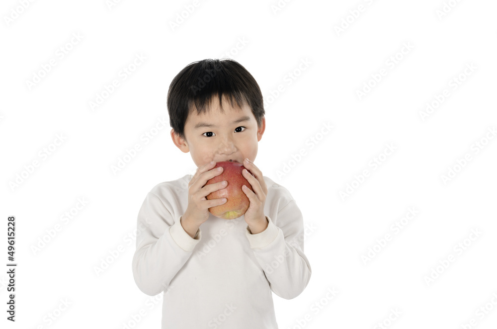 Cute little boy eating an apple with white background Cute little boy eating an apple with white background