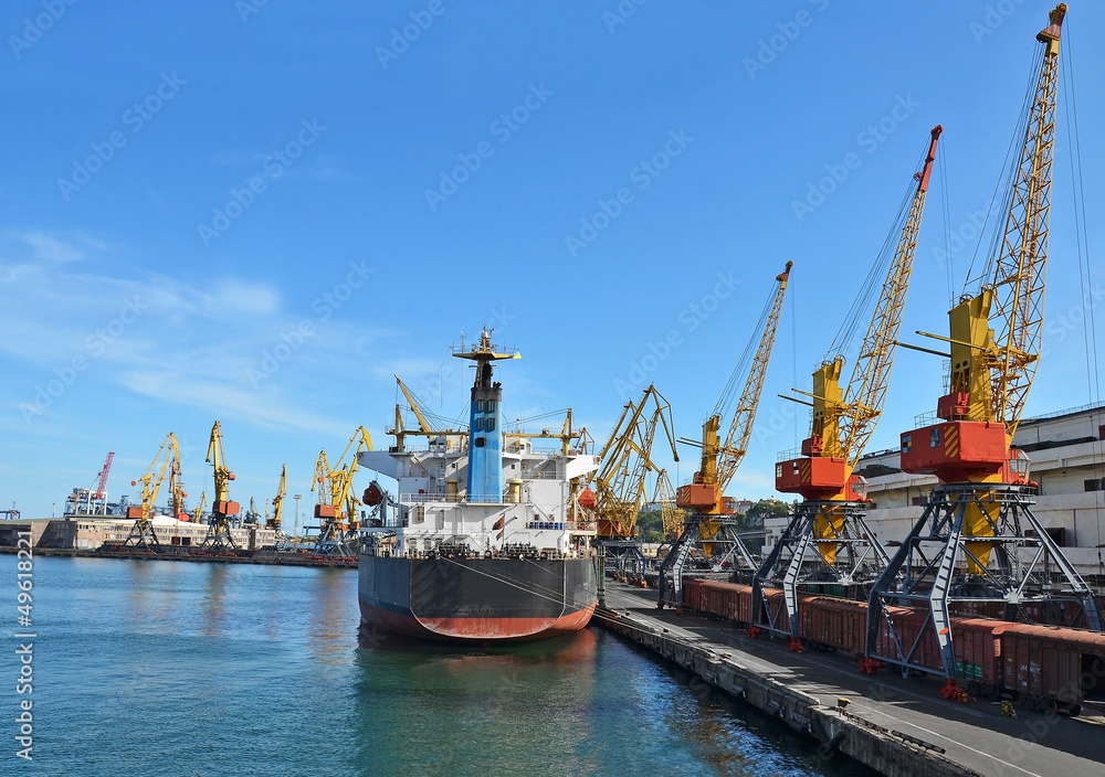 Bulk cargo ship and train under port crane, Odessa, Ukraine