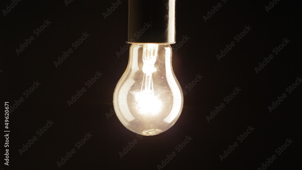Real light bulb turning on, back lit, close-up, HD Real light bulb turning on, back lit, close-up, HD