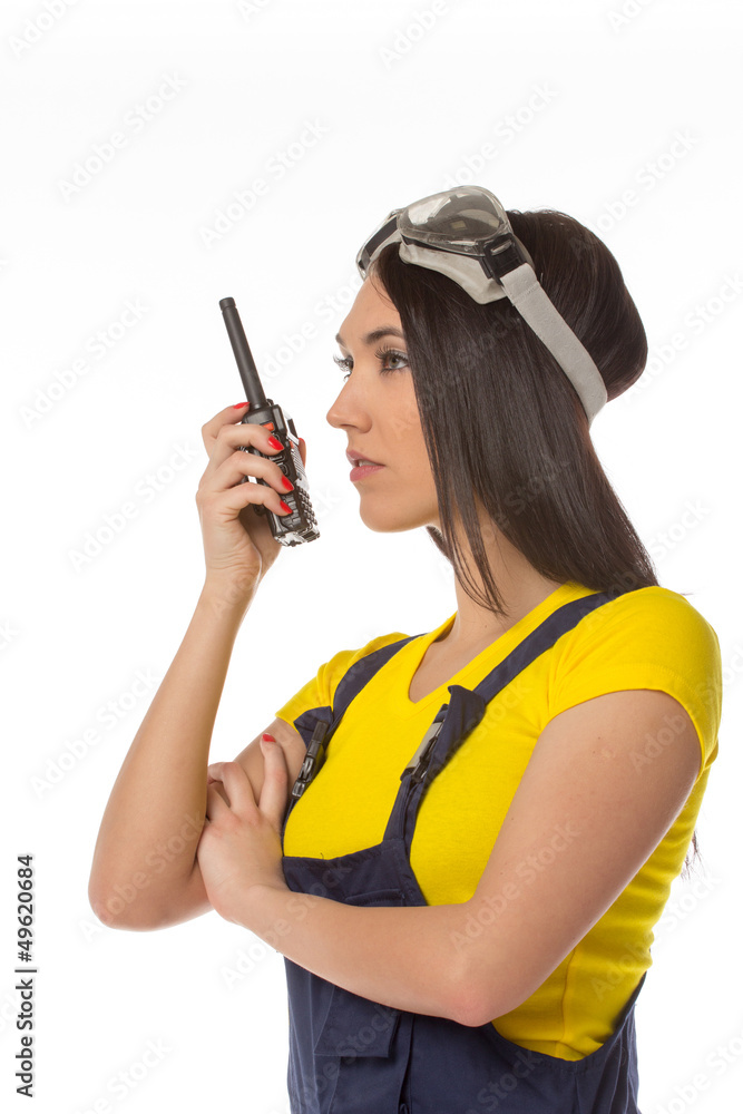 serious female construction worker talking with a walkie talkie serious female construction worker talking with a walkie talkie