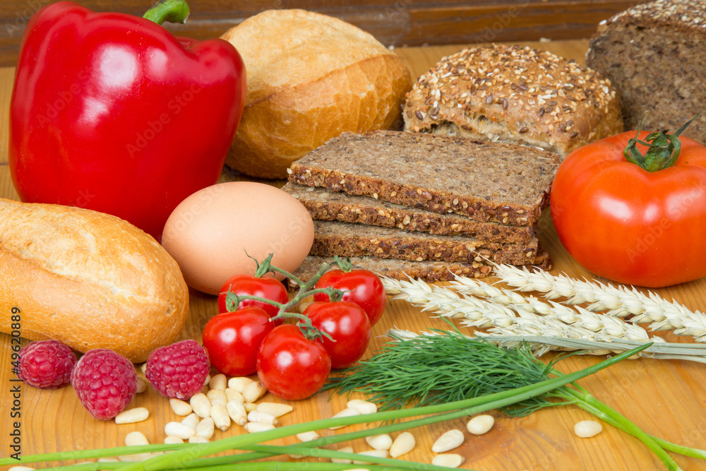 kitchen table with a lot of food like bread and vegetables kitchen table with a lot of food like bread and vegetables