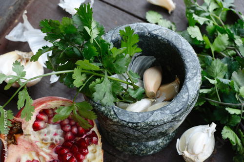 Making dressing of garlic, coriander and pomegranate in Georgian photo