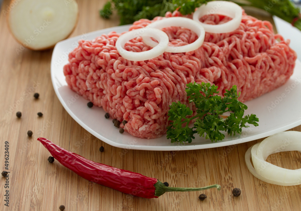 minced meat on the wooden cutting board minced meat on the wooden cutting board