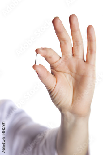 pill in a hand on a white background close-up