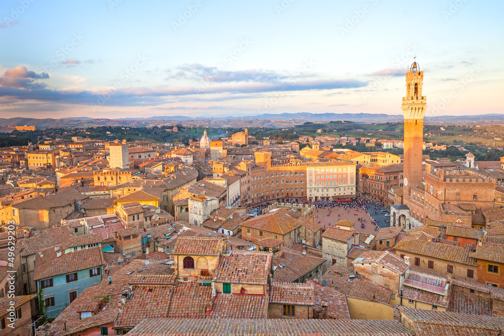 Siena sunset panoramic skyline. Mangia tower landmark. Tuscany,
