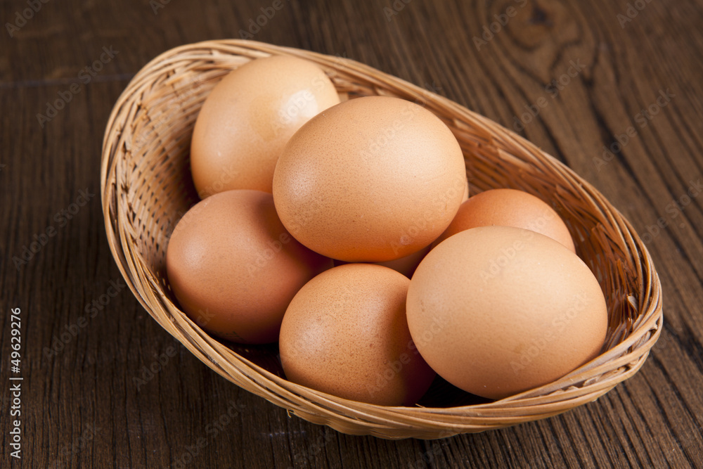 eggs in a bascket on wooden table eggs in a bascket on wooden table