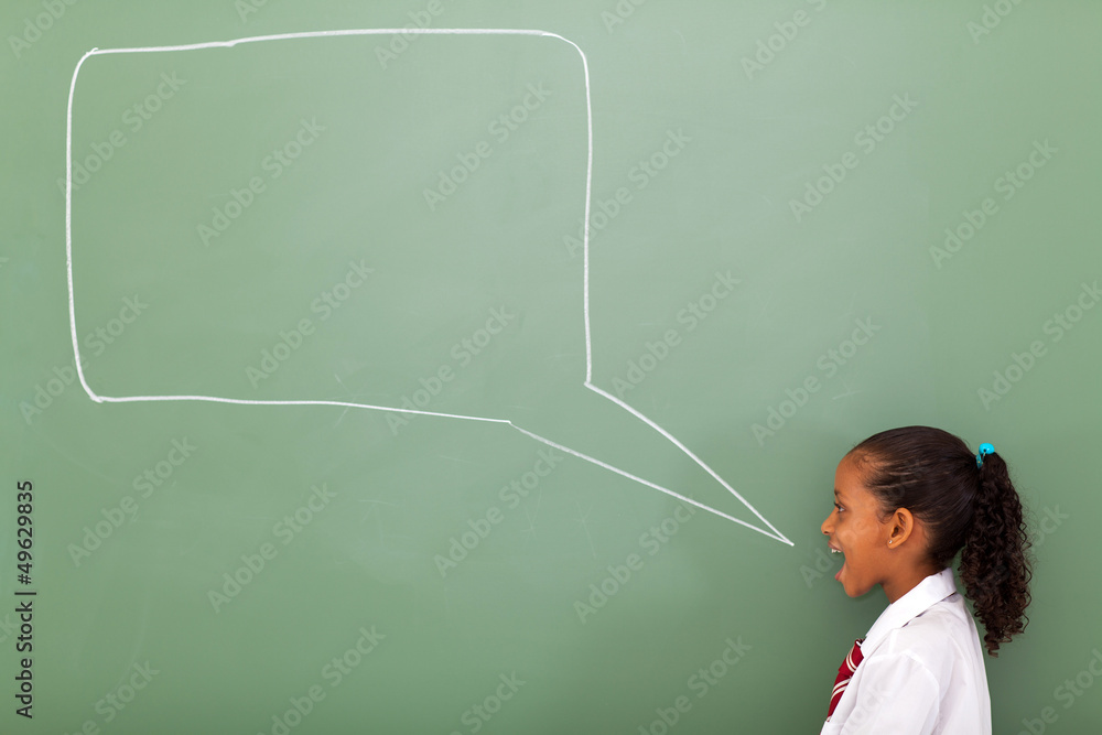 elementary schoolgirl with speech bubble drawn on chalkboard