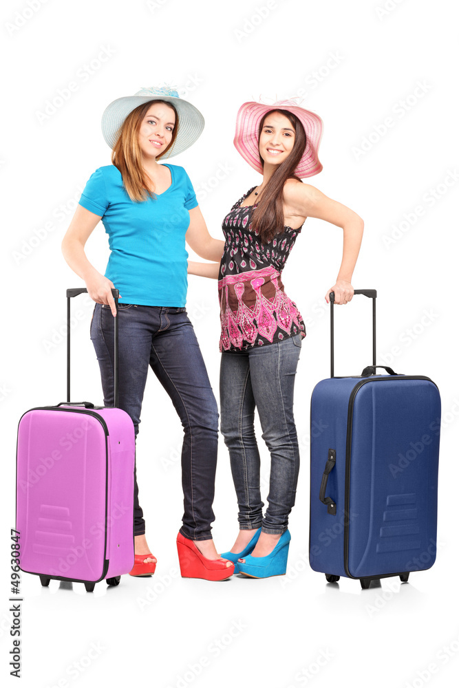 Full length portrait of two teenagers with suitcases ready for j Full length portrait of two teenagers with suitcases ready for j