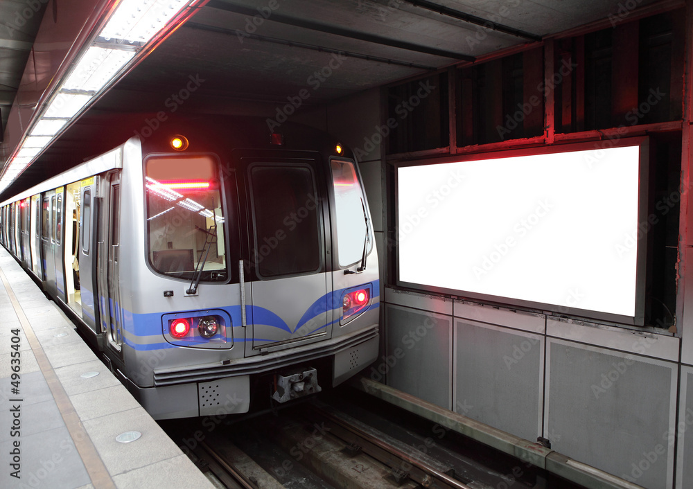 train at metro station with billboard
