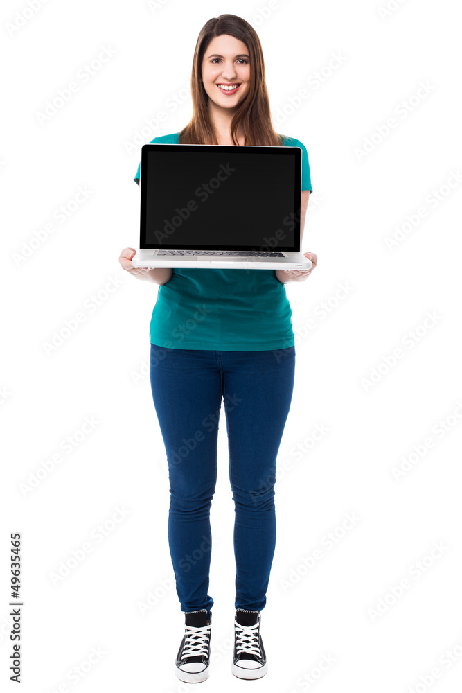 Casual girl presenting brand new laptop Casual girl presenting brand new laptop