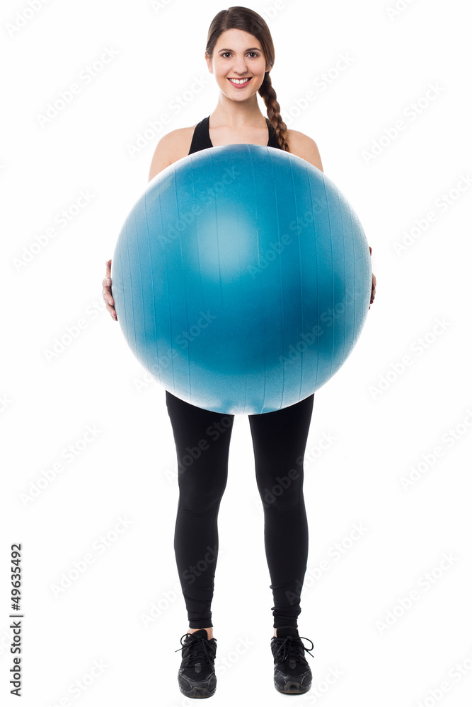 Gym girl presenting a swiss ball Gym girl presenting a swiss ball