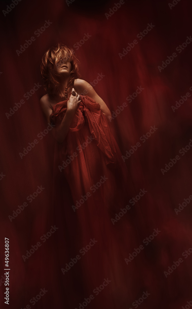 sensual woman in red fabric over art abstract background