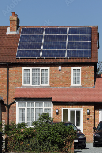 Solar photovoltaic panel array on house roof