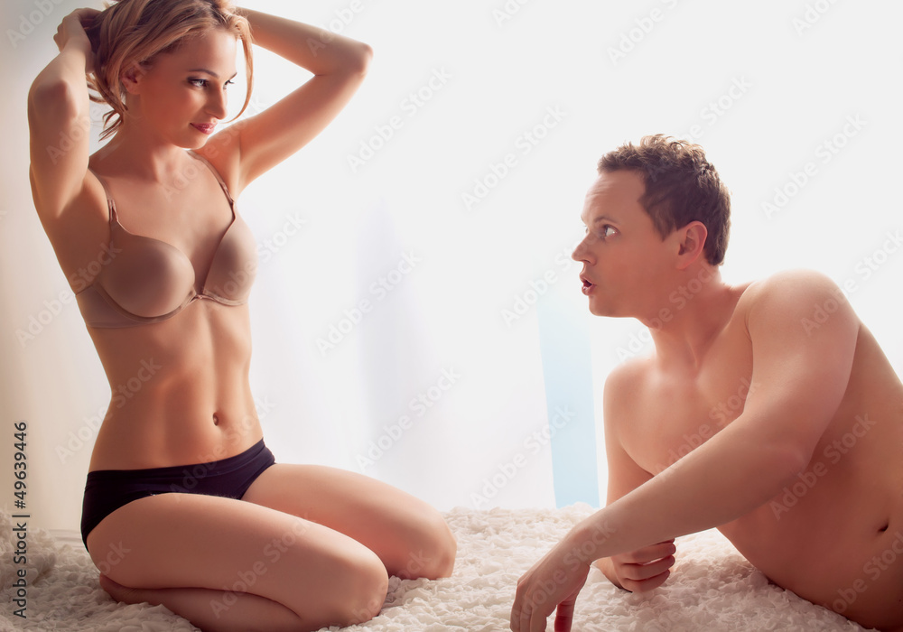 Sexy young couple lay in bed - only lingerie Photos | Adobe Stock