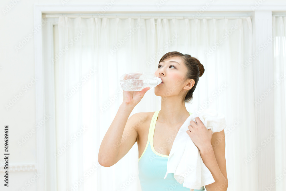 Beautiful young woman drinking water at workout Beautiful young woman drinking water at workout