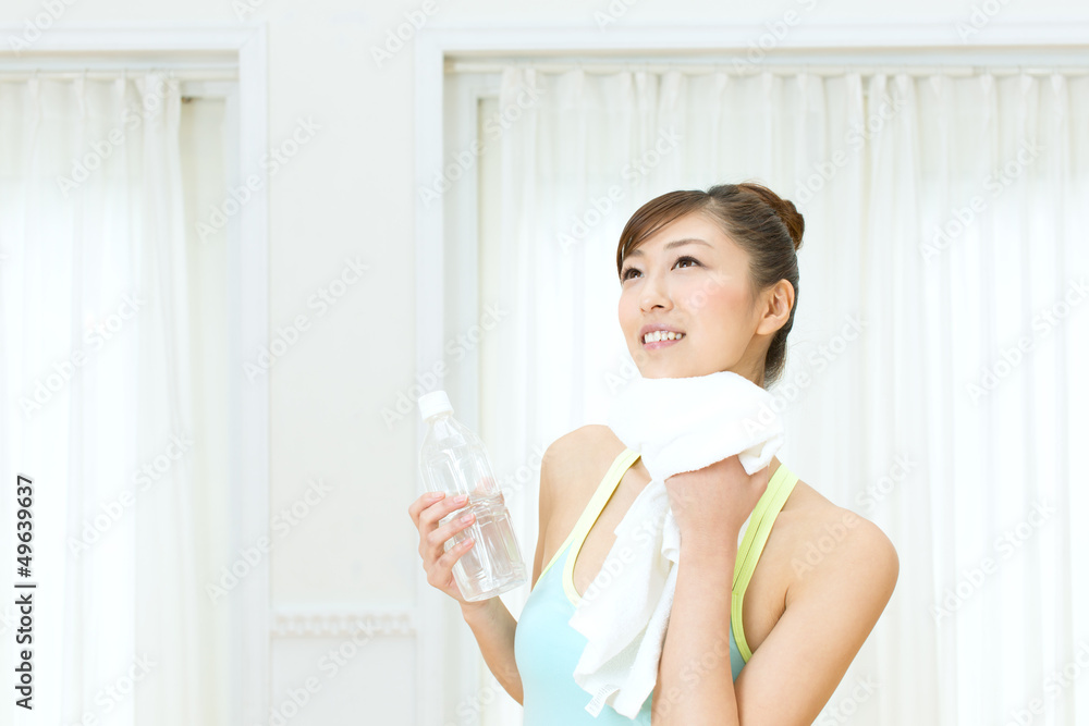Beautiful young woman drinking water at workout Beautiful young woman drinking water at workout