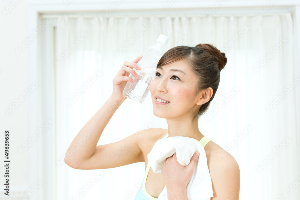 Beautiful young woman drinking water at workout Beautiful young woman drinking water at workout