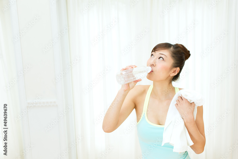 Beautiful young woman drinking water at workout Beautiful young woman drinking water at workout