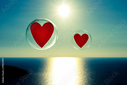 Two floating hearts in bubbles