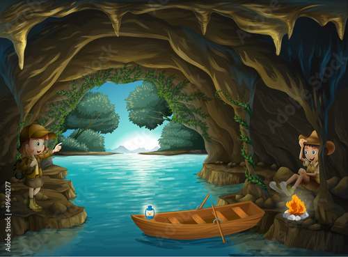 A young girl and boy inside the cave