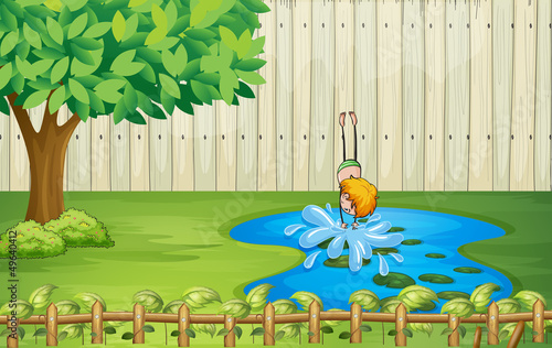 A boy diving in the pond