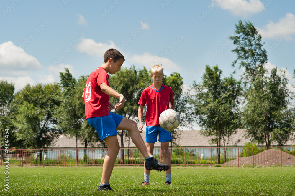 two young football players jogging outside two young football players jogging outside