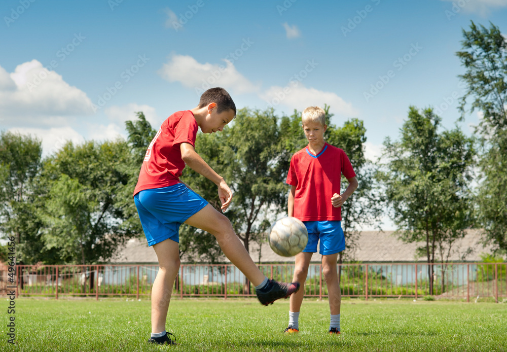 two young football players jogging outside two young football players jogging outside