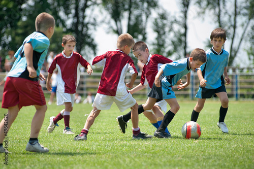 Fototapeta Naklejka Na Ścianę i Meble -  kids playing football outside