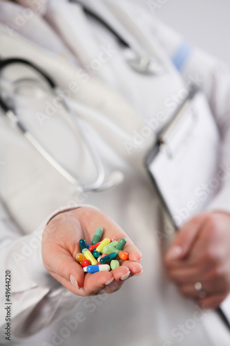 Doctor showing a handful of pills