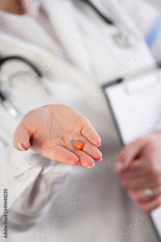 Doctor showing a pill