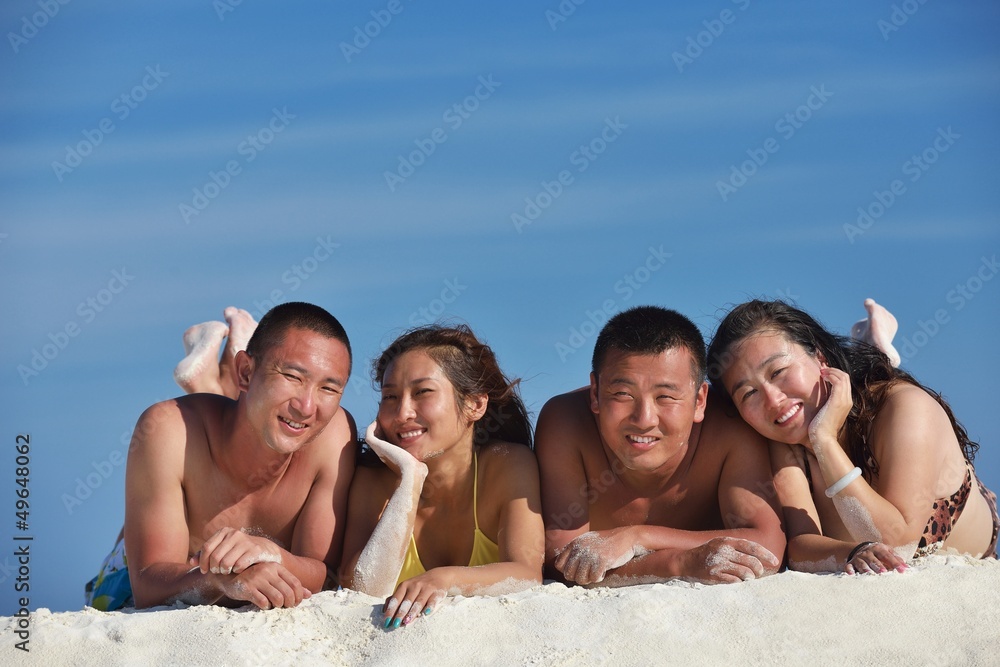 group of happy young people have fun on bach group of happy young people have fun on bach