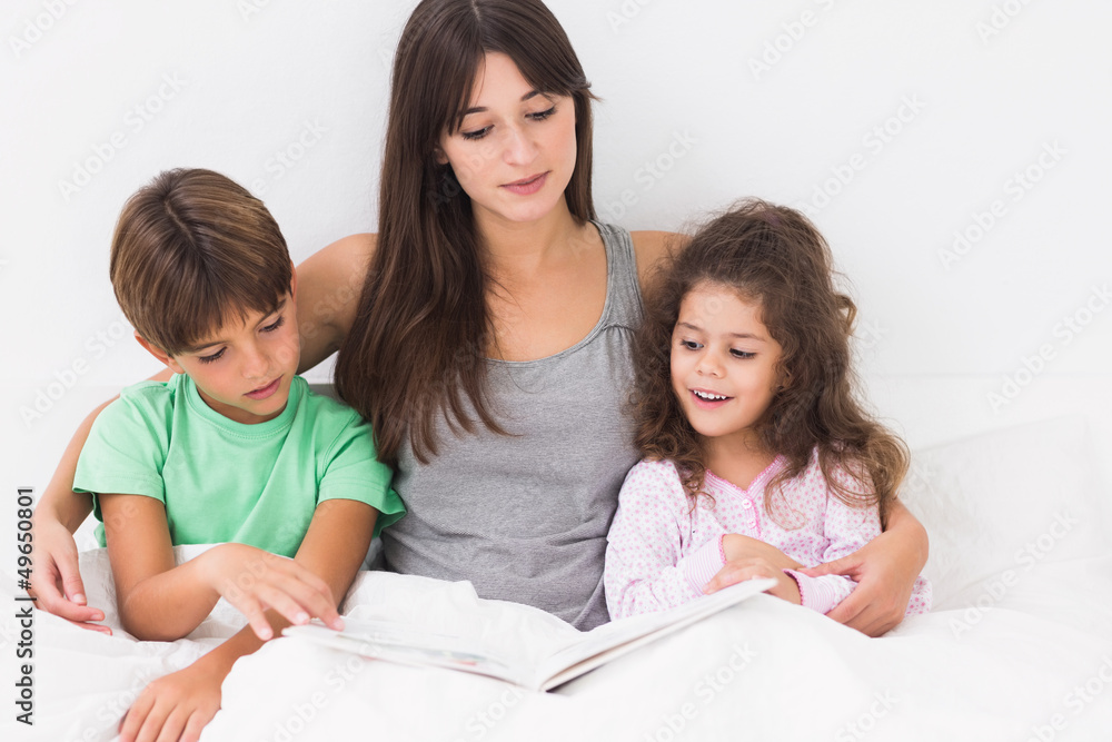 Mother and children reading storybook Mother and children reading storybook