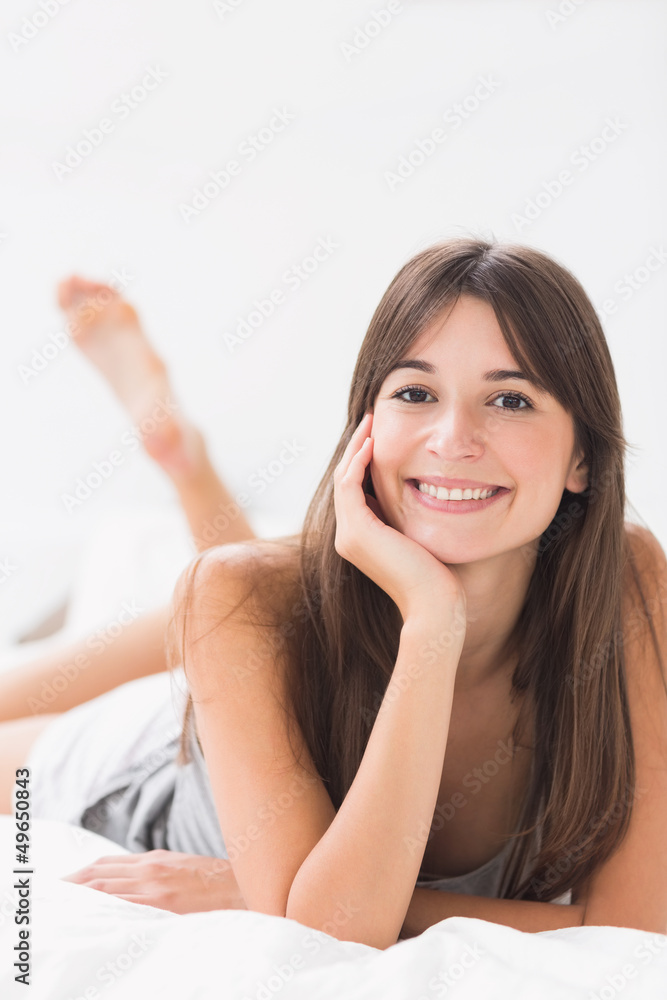 Smiling woman lying in bed Smiling woman lying in bed
