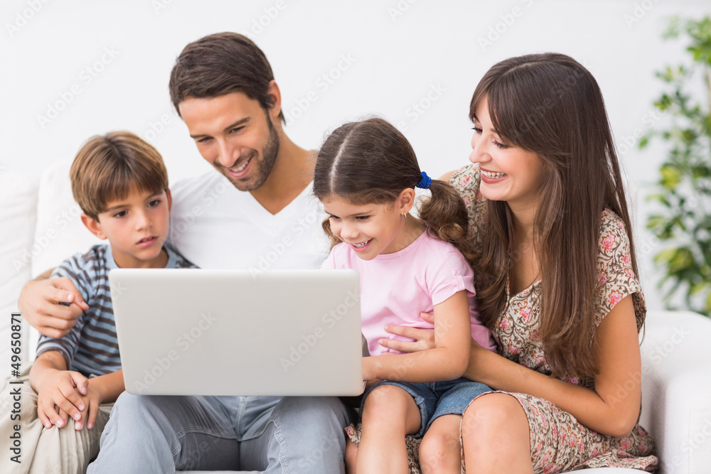 Family using laptop together Family using laptop together