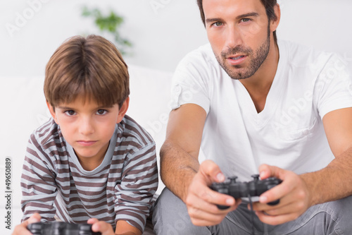 Father and son playing video games together