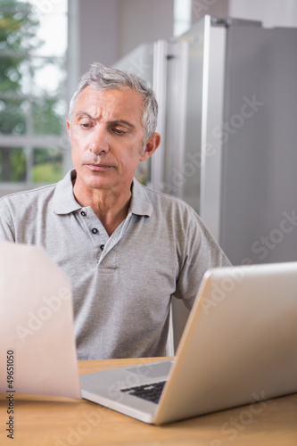 Thoughtful man using his laptop © WavebreakmediaMicro