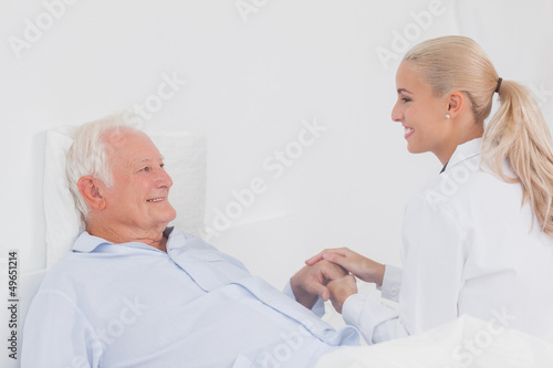 Doctor comforting elderly patient