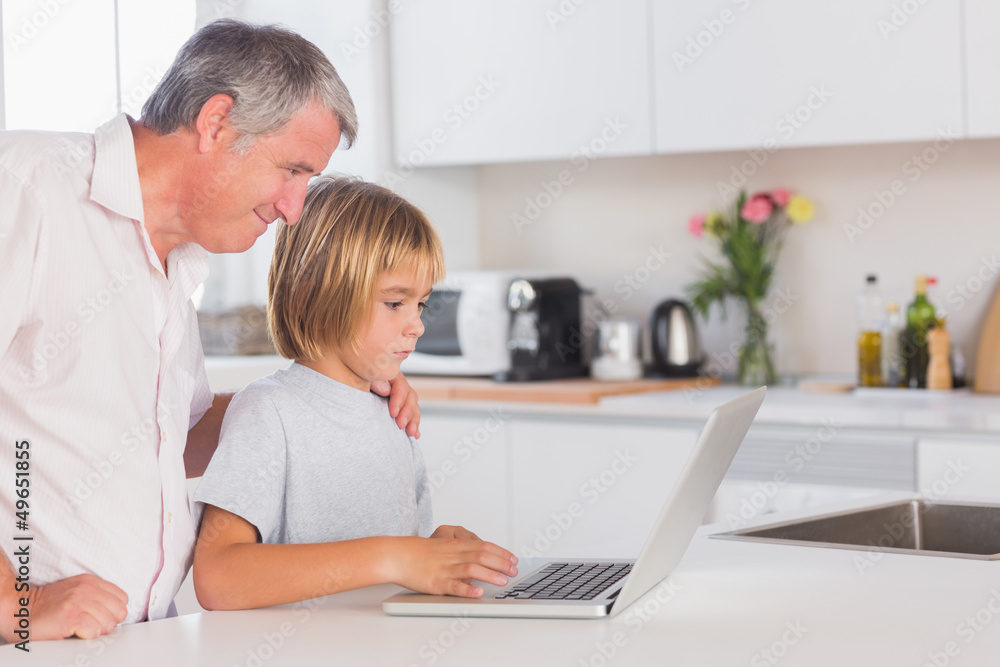 Child and grandfather looking at laptop Child and grandfather looking at laptop