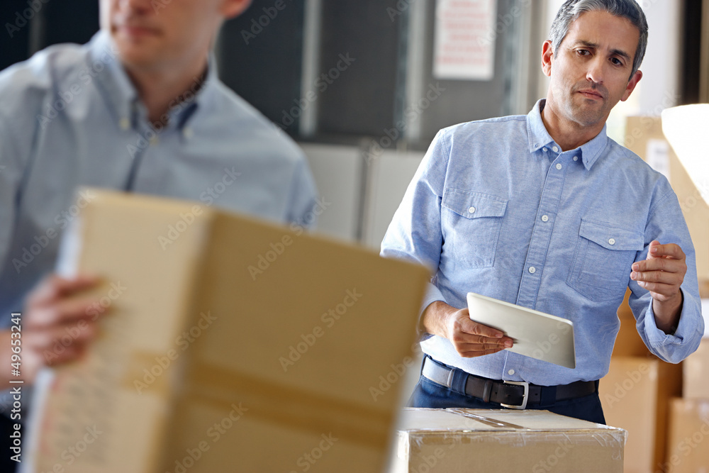 Fototapeta premium Manager Using Tablet Computer In Distribution Warehouse