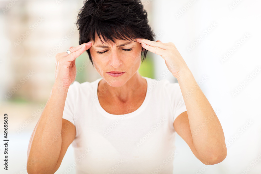 mid age woman having headache and massaging forehead mid age woman having headache and massaging forehead