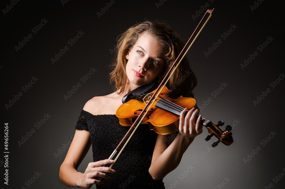 Woman performer with violin in studio